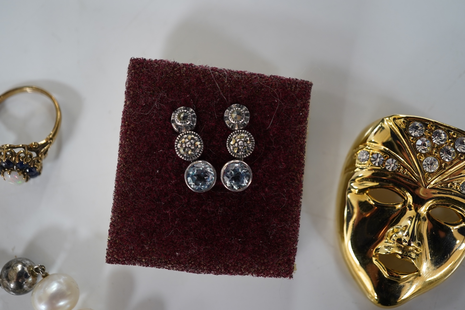 A collection of jewels, comprising: an opal and sapphire cluster ring and a citrine ring in 9ct gold, each with British hallmarks, combined gross weight approximately 4 grams; together with a pair of blue topaz and marca